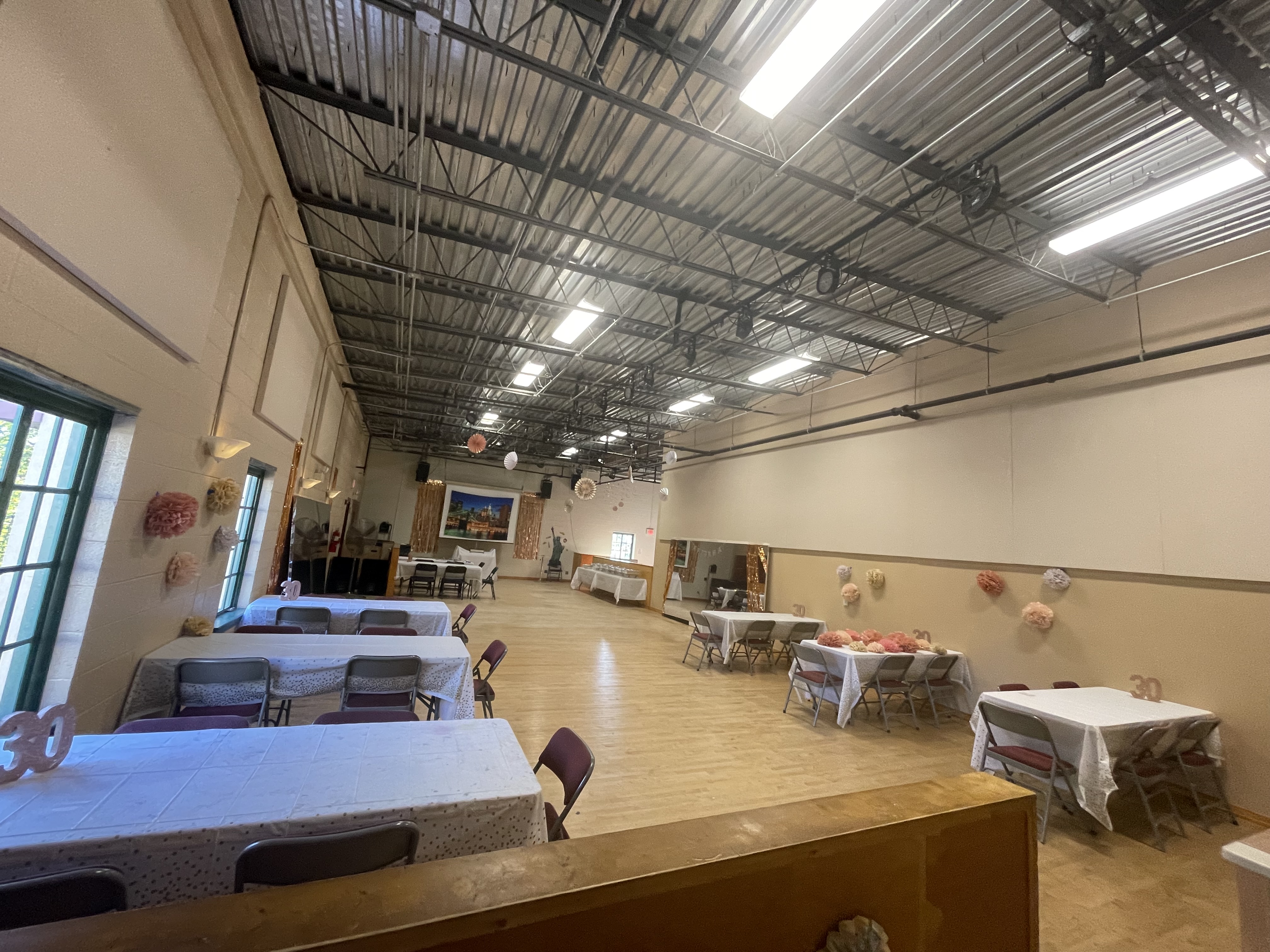 A space with hardwood floors and tables