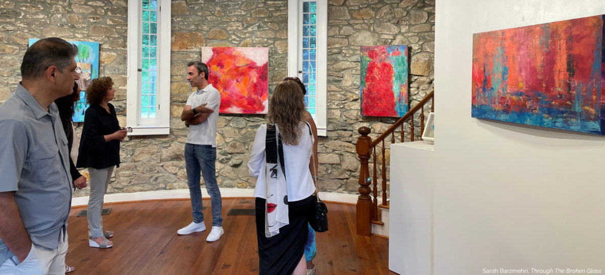 Woman looks at artwork displayed on the walls of the Stone Tower Gallery